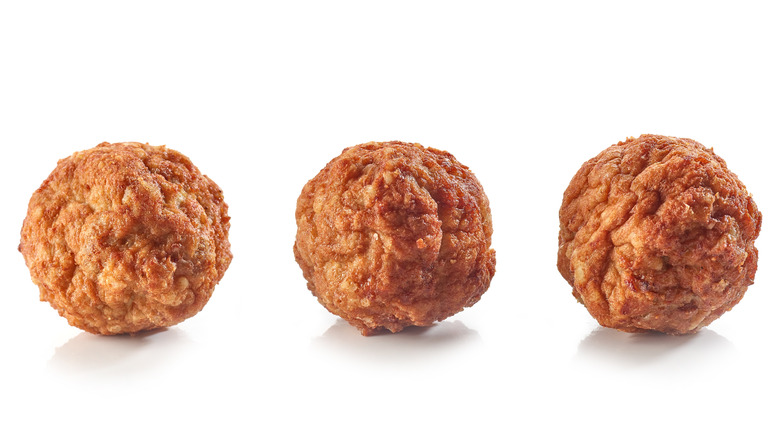 Three meatballs on white background