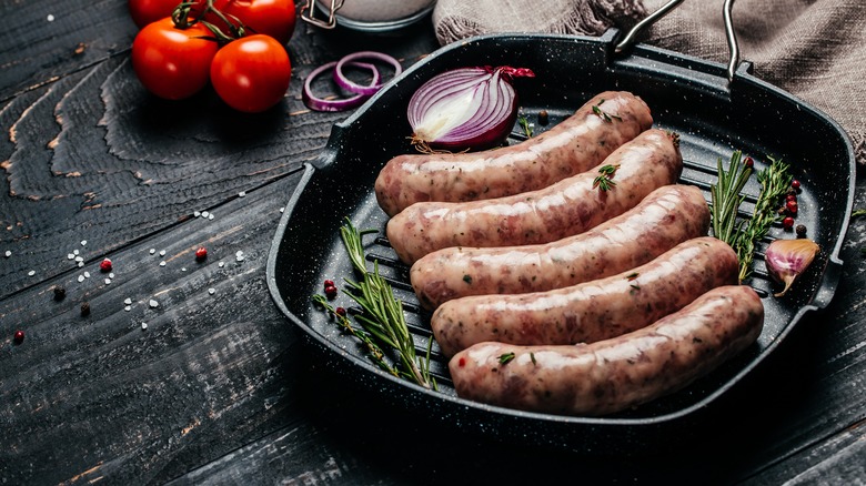raw sausages in a pan