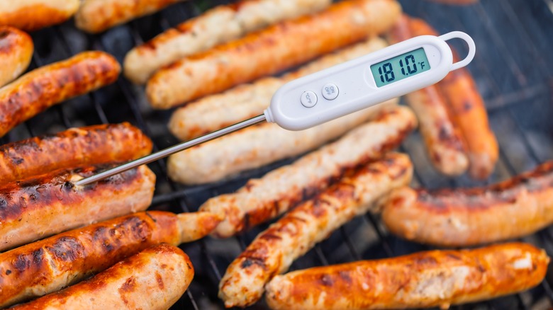 Thermometer in sausage on grill