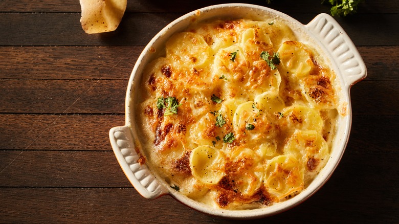 scalloped potatoes in ceramic dish