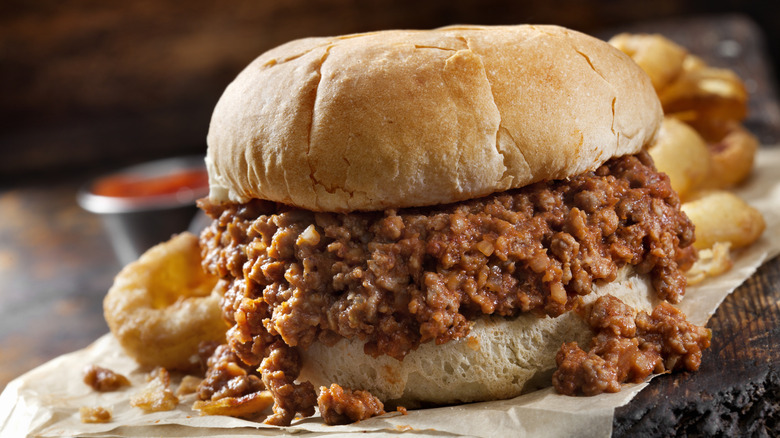 Sloppy joe in bun with onion rings