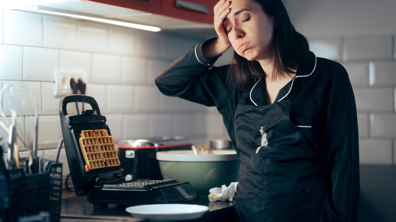 Woman stressed with waffle maker