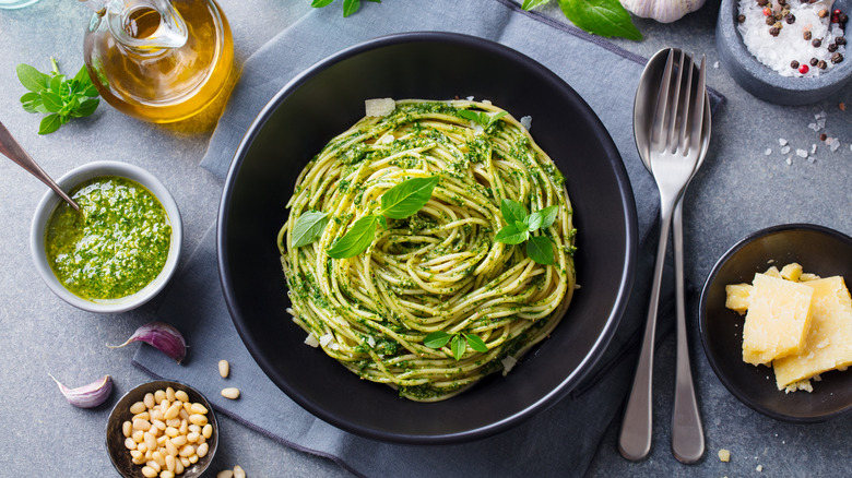 bowl of pesto spaghetti and ingredients