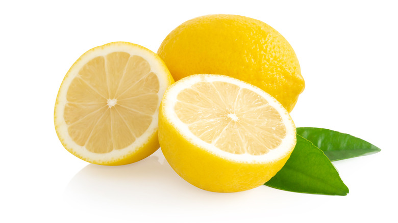 Cut lemons on white background