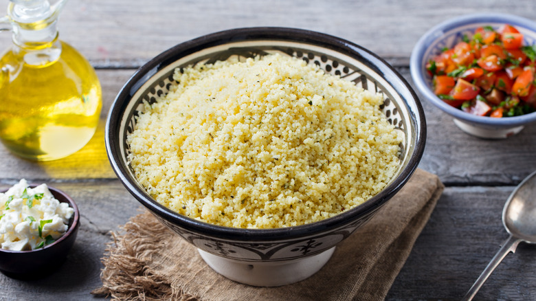bowl of couscous with toppings on the side