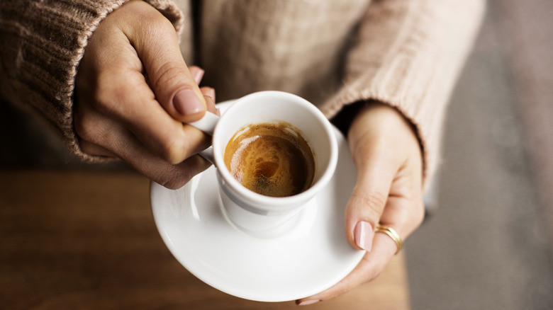 Woman drinking an espresso 