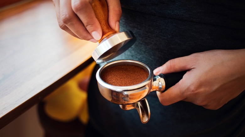 Man tamping an espresso