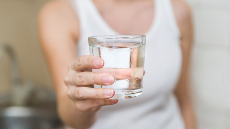 Woman holding glass of water