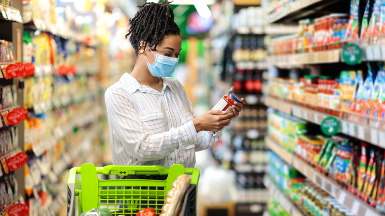 woman reading food expiration label