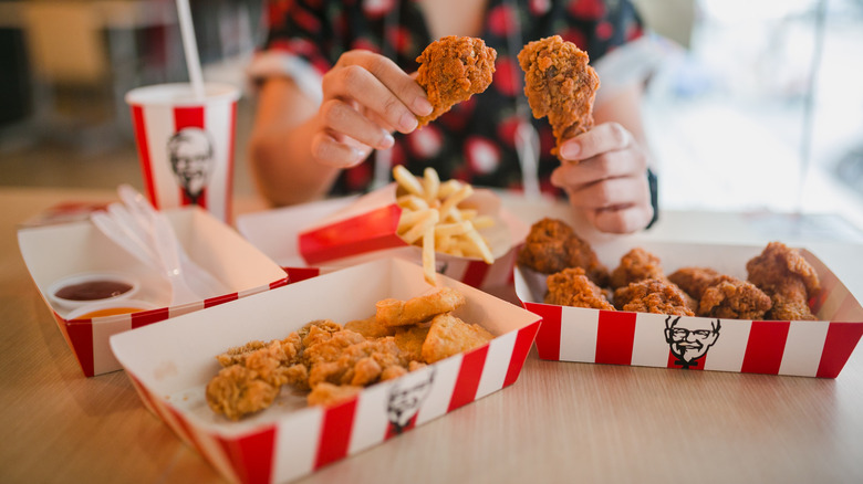 person holding KFC chicken wings