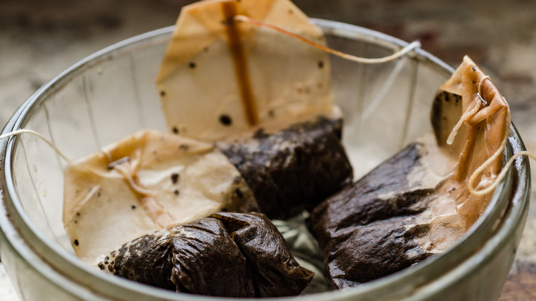 Spent tea bags in bowl
