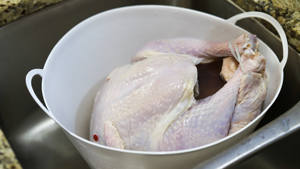 raw meat in pot in sink