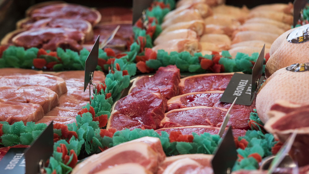 Row of raw meat in a butcher case