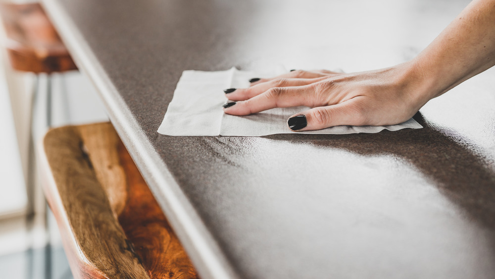 Woman cleaning table of raw meat