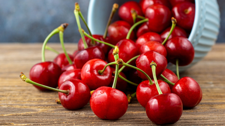 cherries with stems on table with ramekin