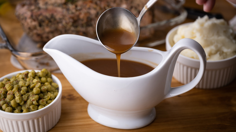 gravy pouring from ladle into gravy boat