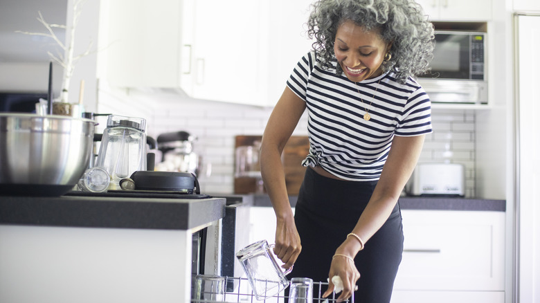 woman loading dishwasher