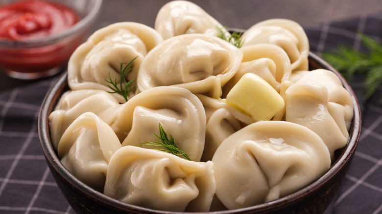 dumplings in a bowl topped with butter