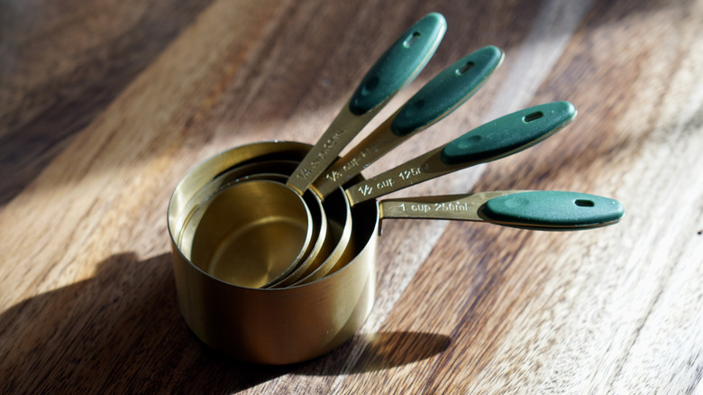 Set of measuring cups on a wooden surface