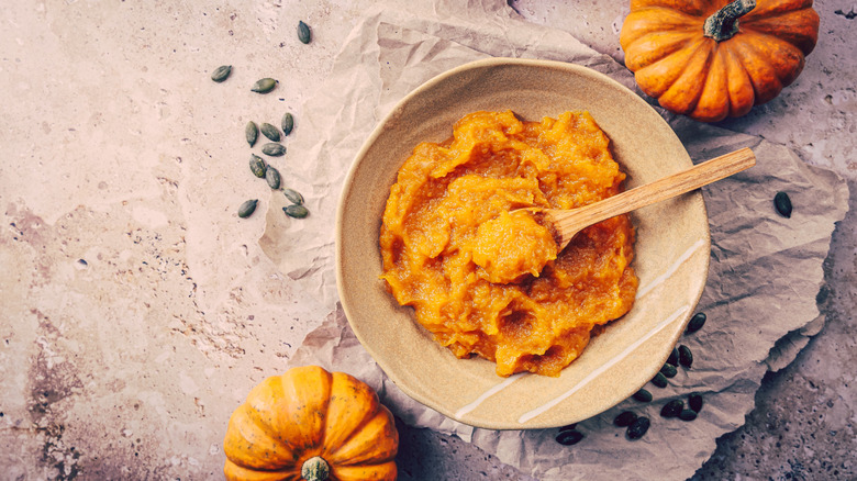 Bowl of pumpkin puree and mini pumpkins