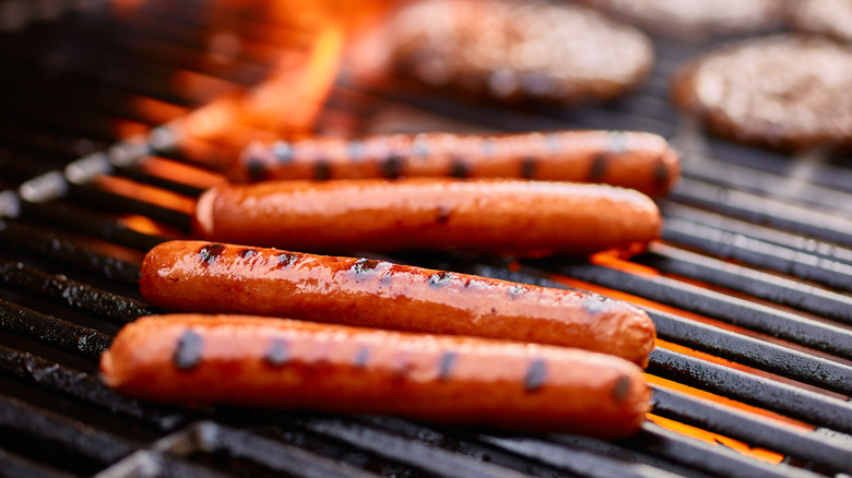 hot dogs and hamburgers on a grill