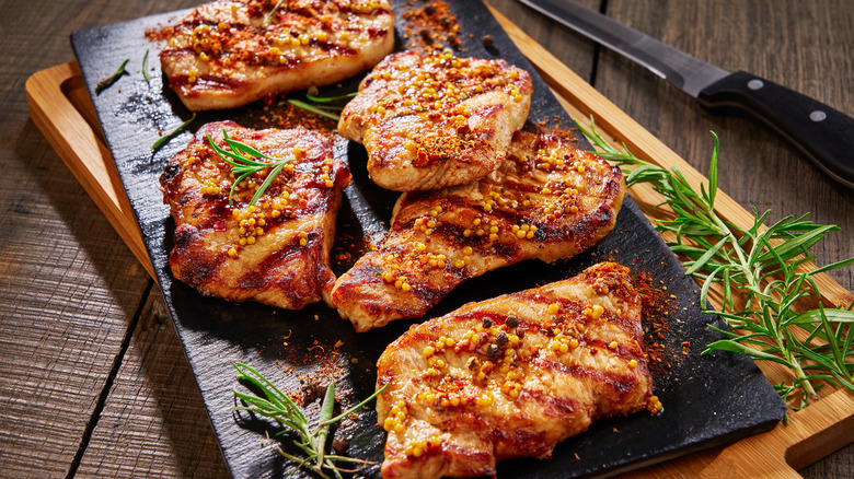 pork chops cooking on grill