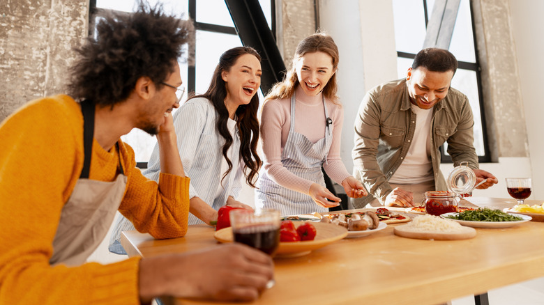 Group of friends hanging out, making pizza