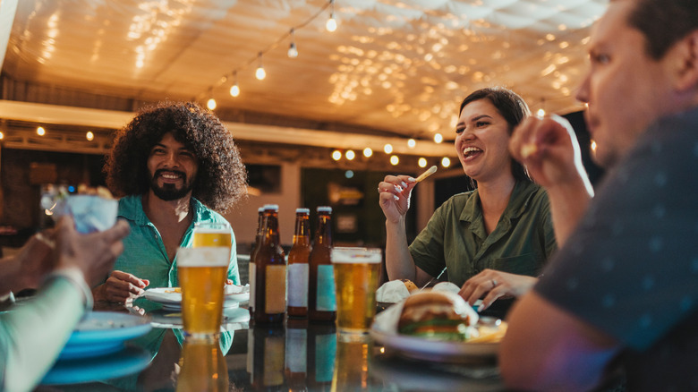Group of friends drinking beer with dinner