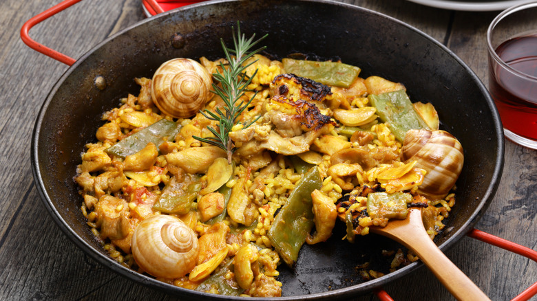 Traditional paella in pan showing socarrat
