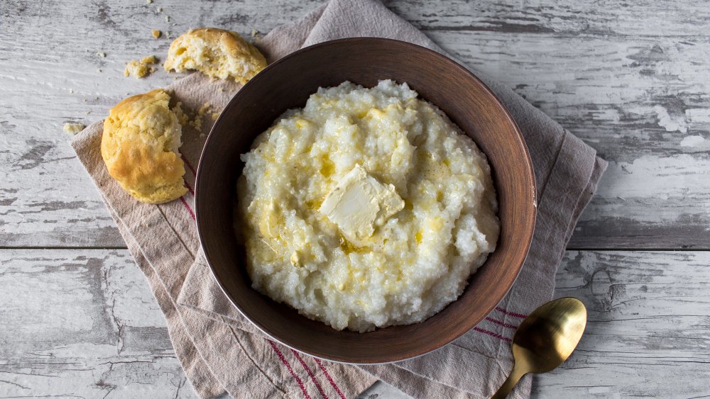 bowl of grits with a biscuit