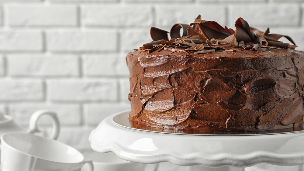 chocolate frosted cake on pedestal