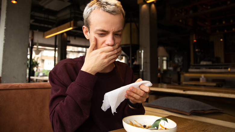 person disliking flavor of meal