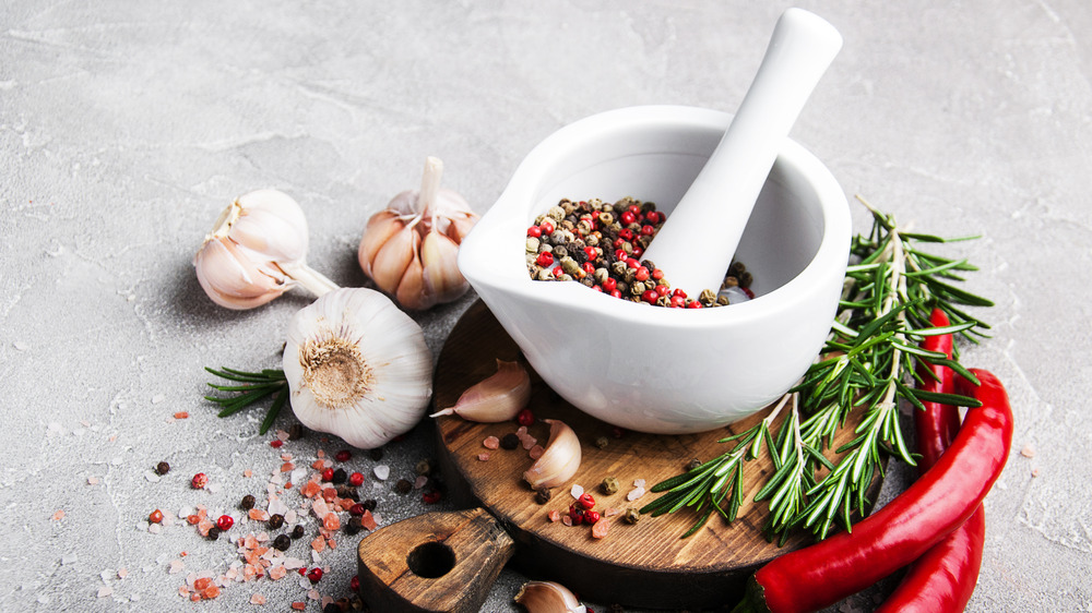 Mortar and pestle with spices and garlic