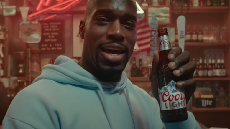 man smiling with beer bottle