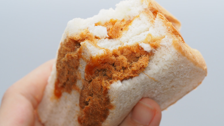 hand holding pork floss sandwich 