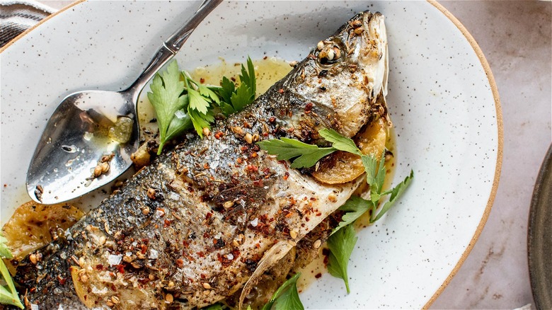 whole roasted branzino on plate