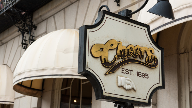 White awnings and "Cheers" sign