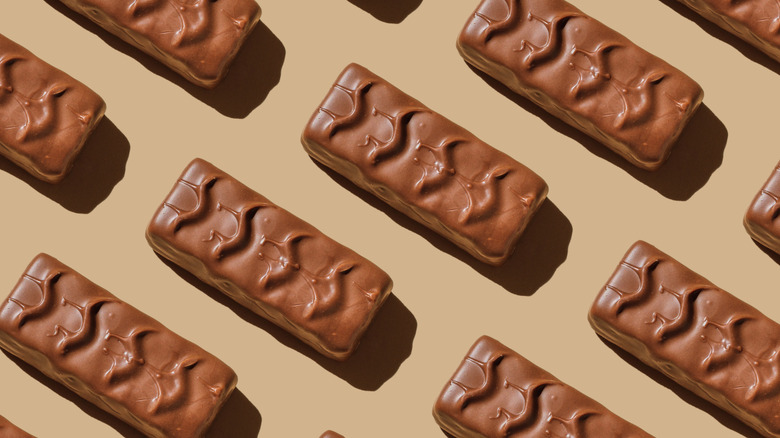 Chocolate candy bars laying on a beige table