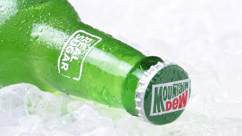 A bottle of Mountain Dew lying in ice