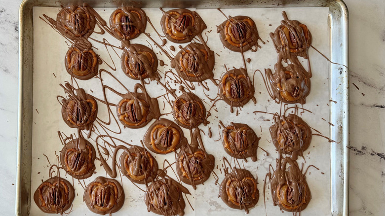 Pretzel chocolate turtles on baking sheet
