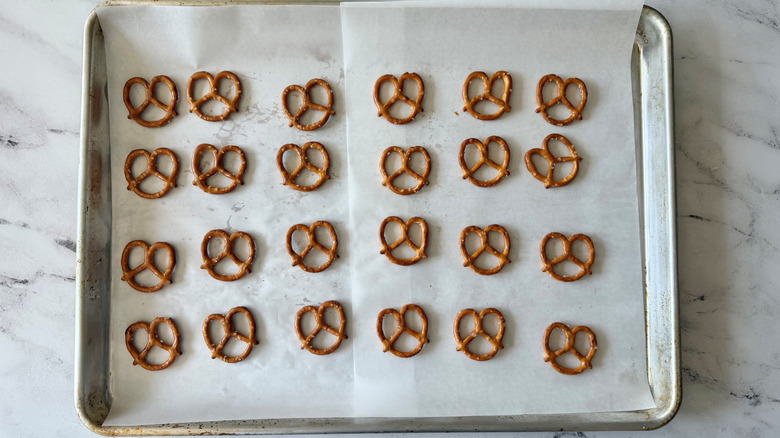 Pretzels lined up on baking sheet