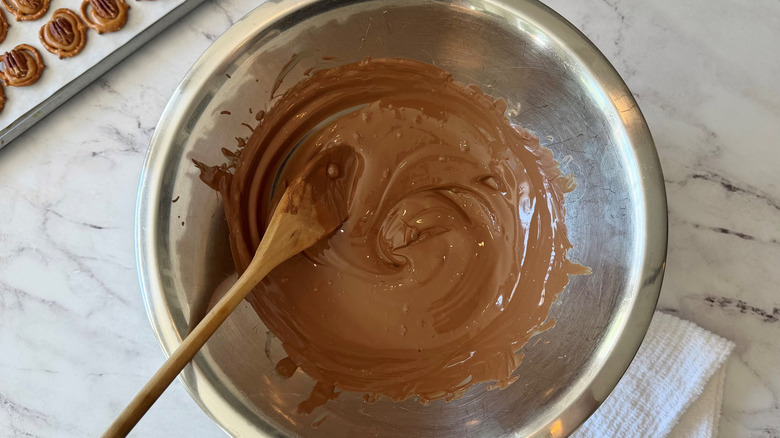 Melted chocolate in bowl with wooden spoon