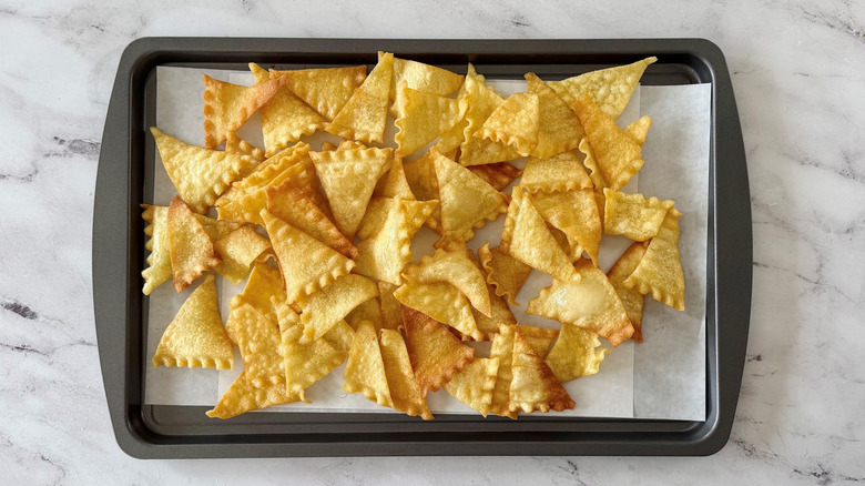 Fried lasagna chips on baking sheet