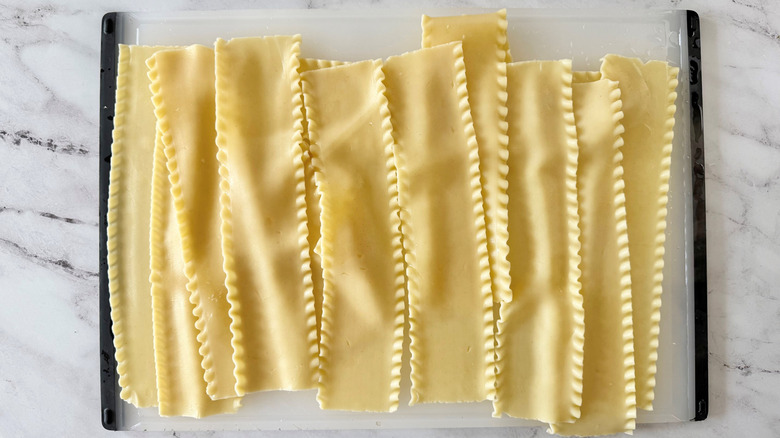 Cooked lasagna noodles on cutting board
