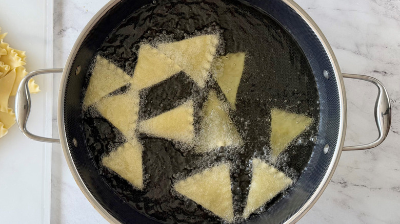Pasta triangles frying in oil