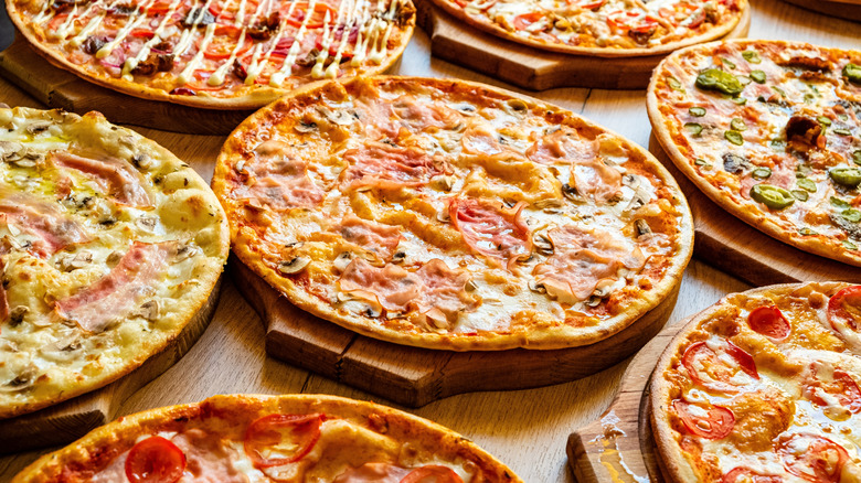 Collection of various pizzas on a table