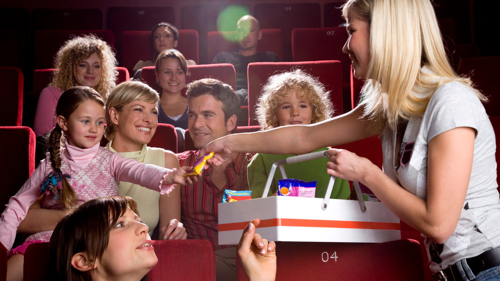 Family buying candy and popcorn at the movie theater