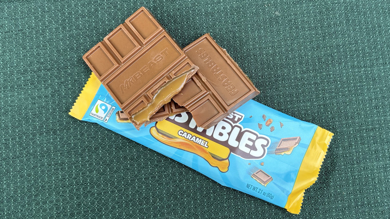 Feastables caramel bar broken in half