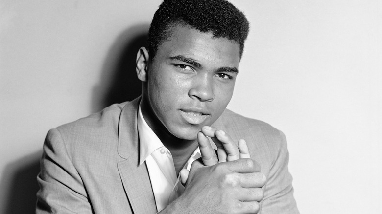 Muhammad Ali poses wearing collared shirt and jacket