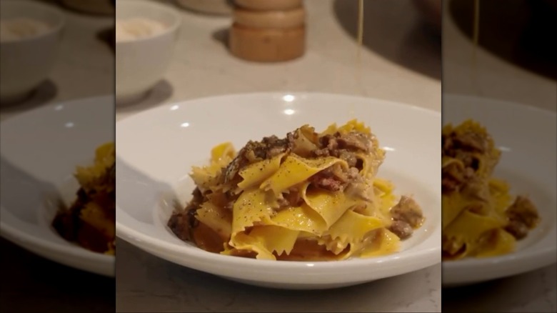 White plate of creamy, flat pasta.